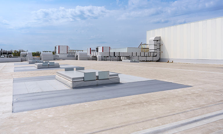 Flat commercial roofing installation by Wolf River Construction, showcasing durable materials and energy-efficient, high-quality roofing solutions for industrial buildings.
